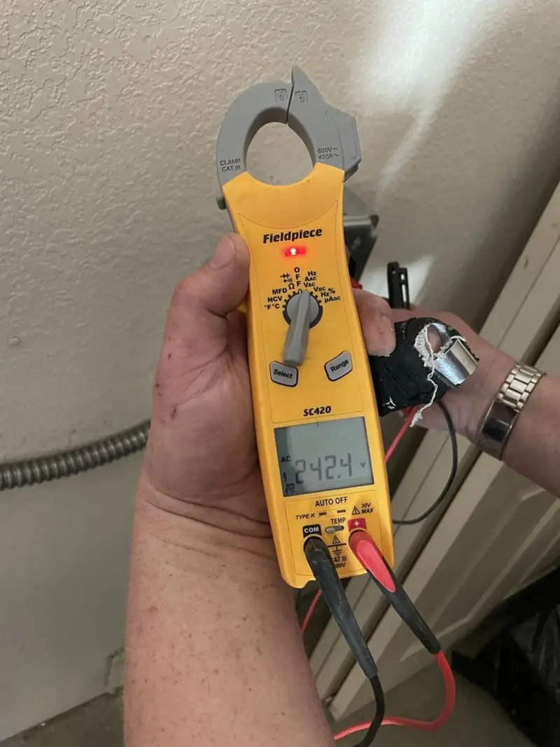 Voltage testing with clamp meter during Ceiling Fan Installation in Lowesville